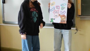 Dwie uczennice prezentują swój projekt o Muhamedzie